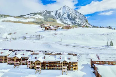Elkhorn Lodging exterior with Crested Butte mountain